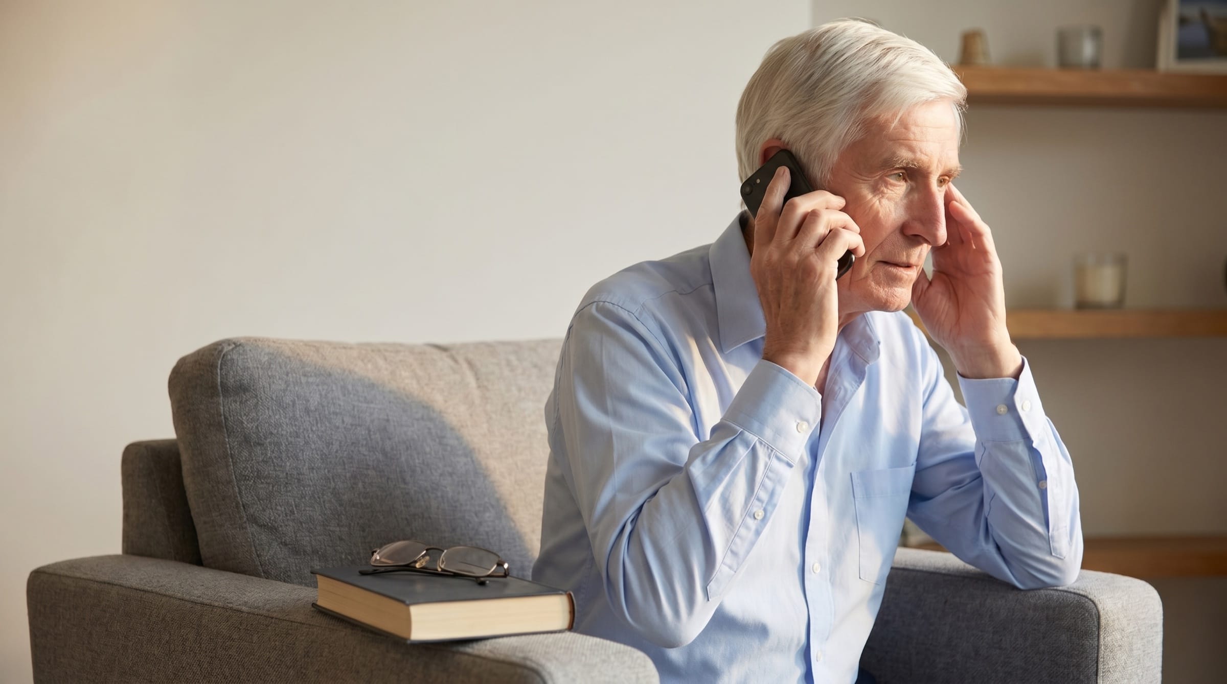 Jeremy Nixey listening to a family in a bright domestic setting.